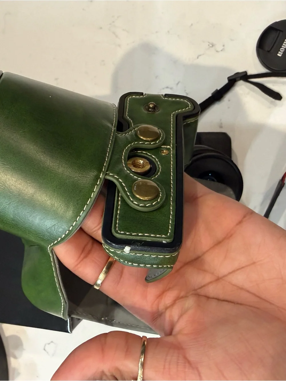 Canon EOS R50 Black Mirrorless Camera with Red-Trim Strap and Green Case